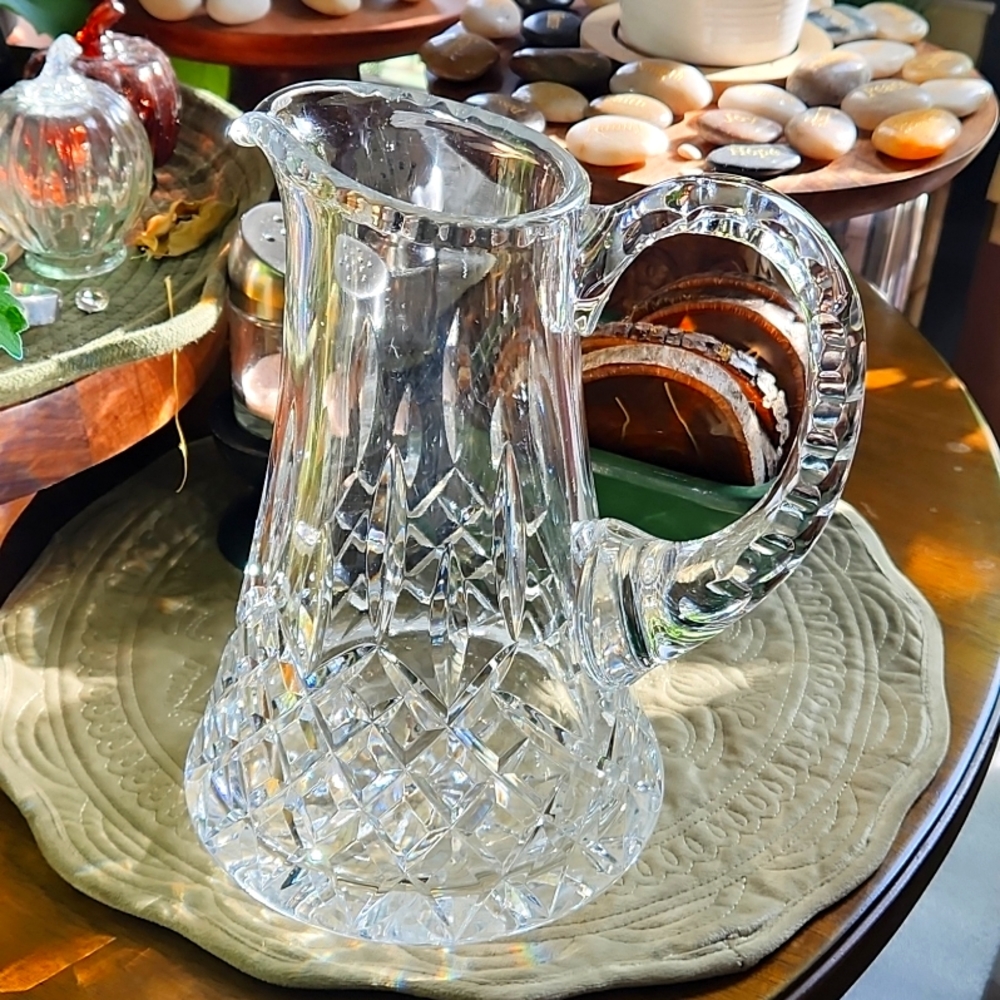 Unique water pitcher 10 1/2 inches tall by 7 inches wide. Very heavy